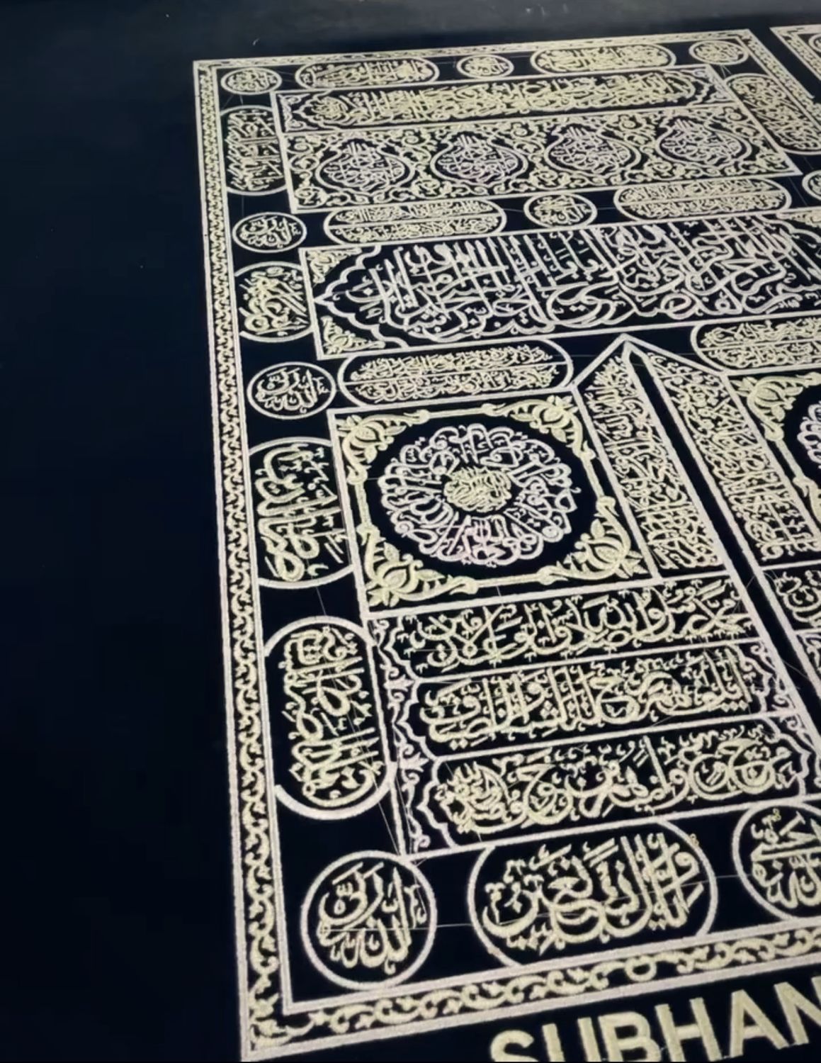 Calligraphy panel stitched in metallic thread on black fabric
