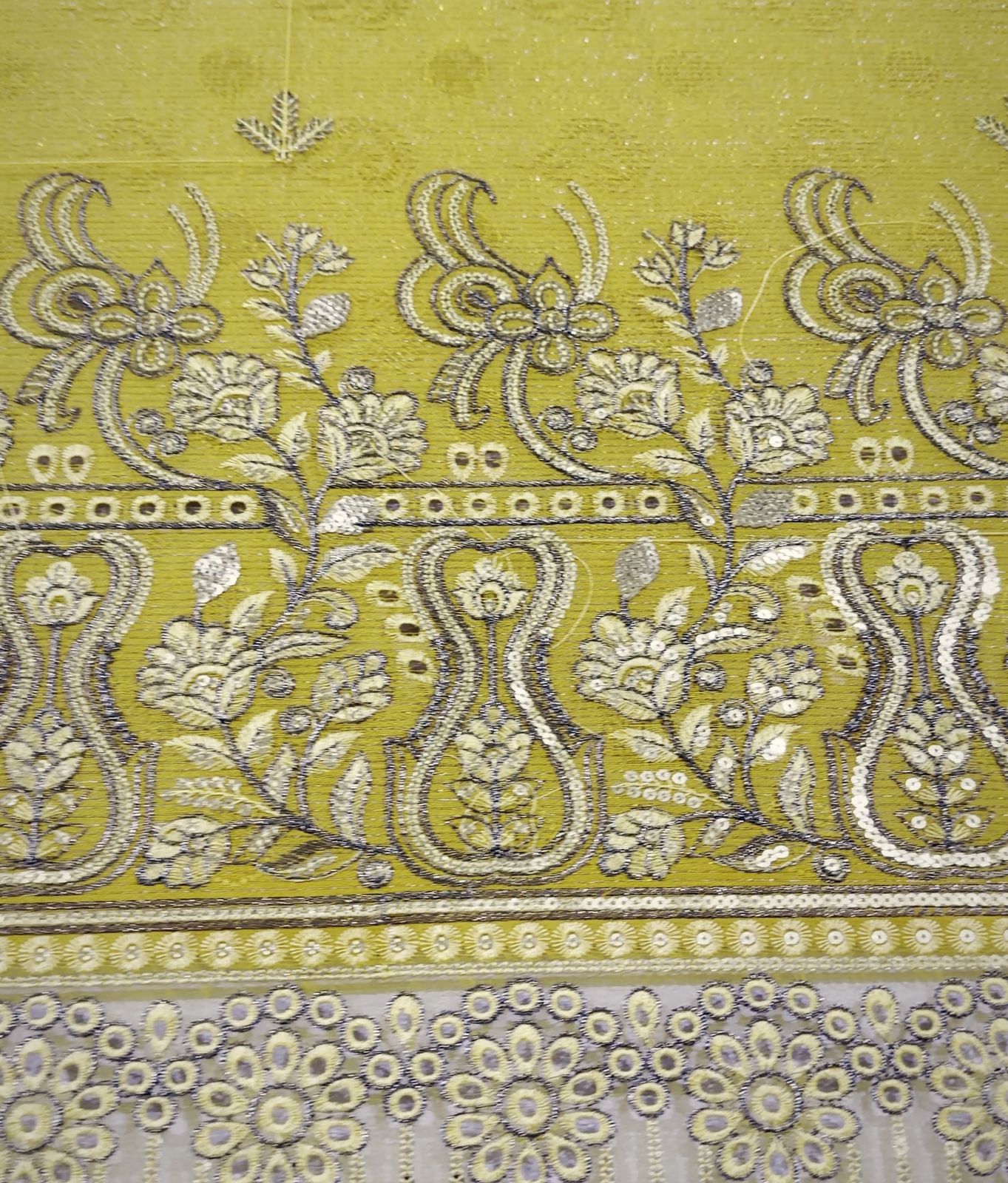 Metallic floral border on ochre fabric