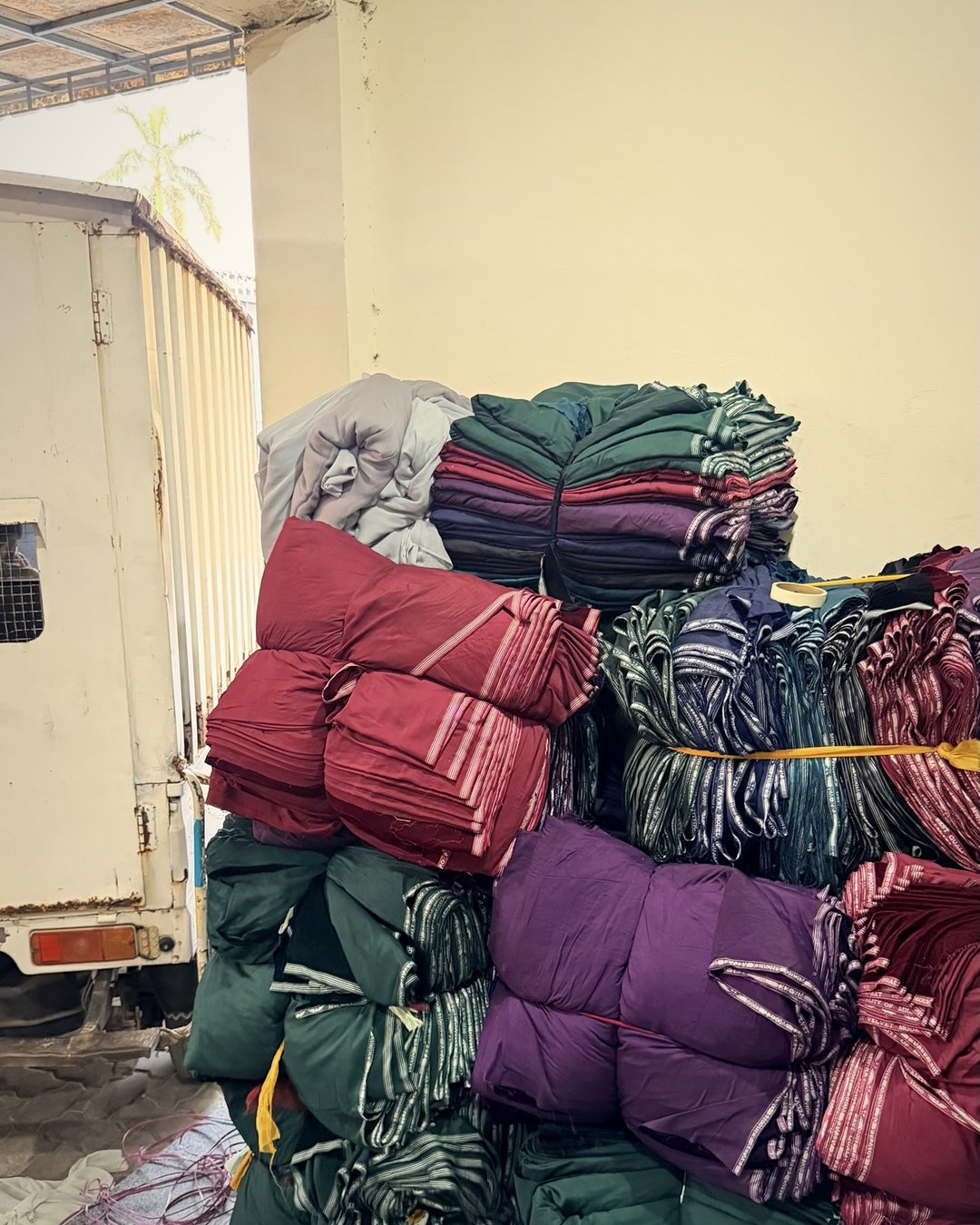 Bundles of raw fabric arriving at the Subhan Tex fabric store