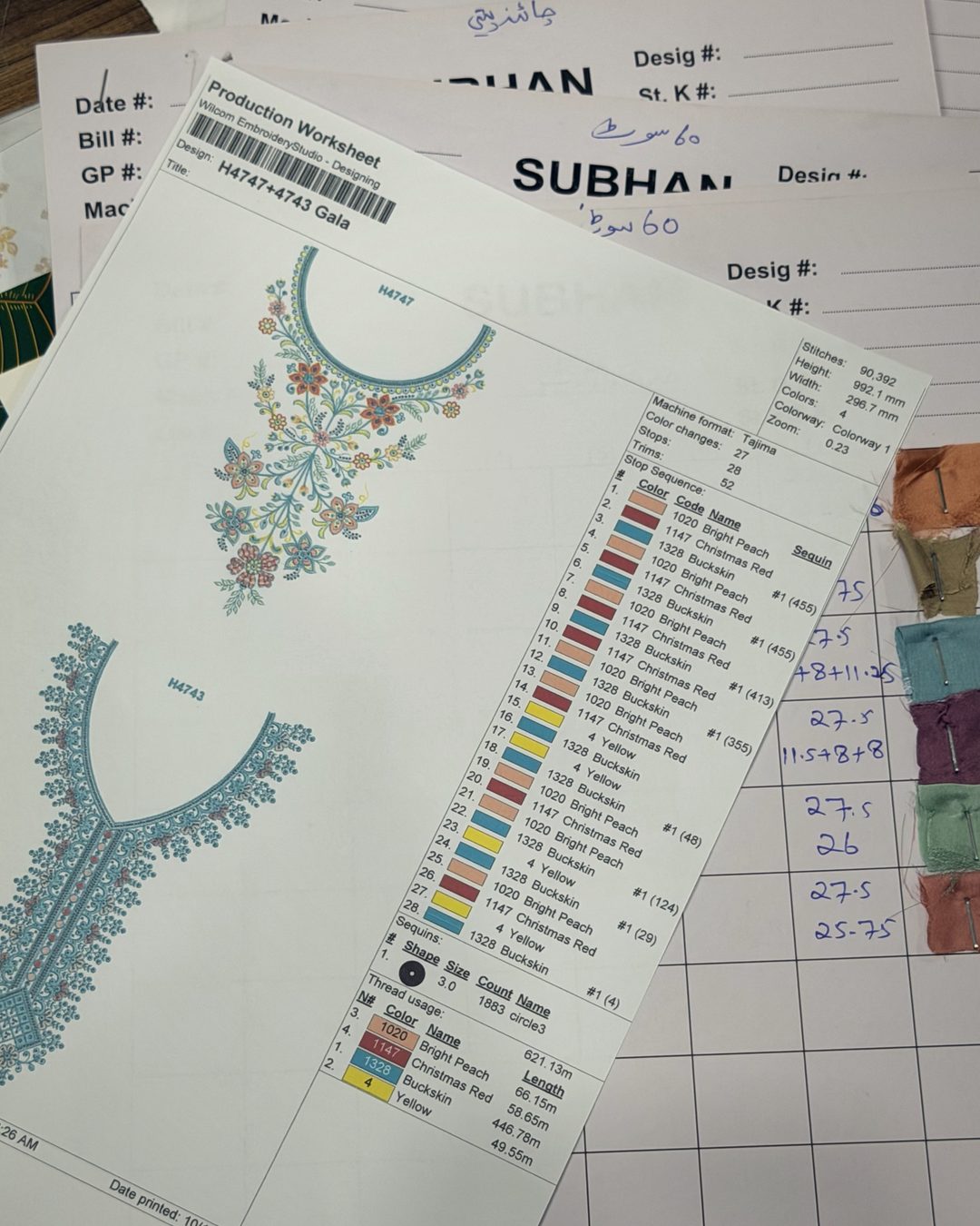 Production worksheets on top of Subhan Tex job cards and fabric swatches