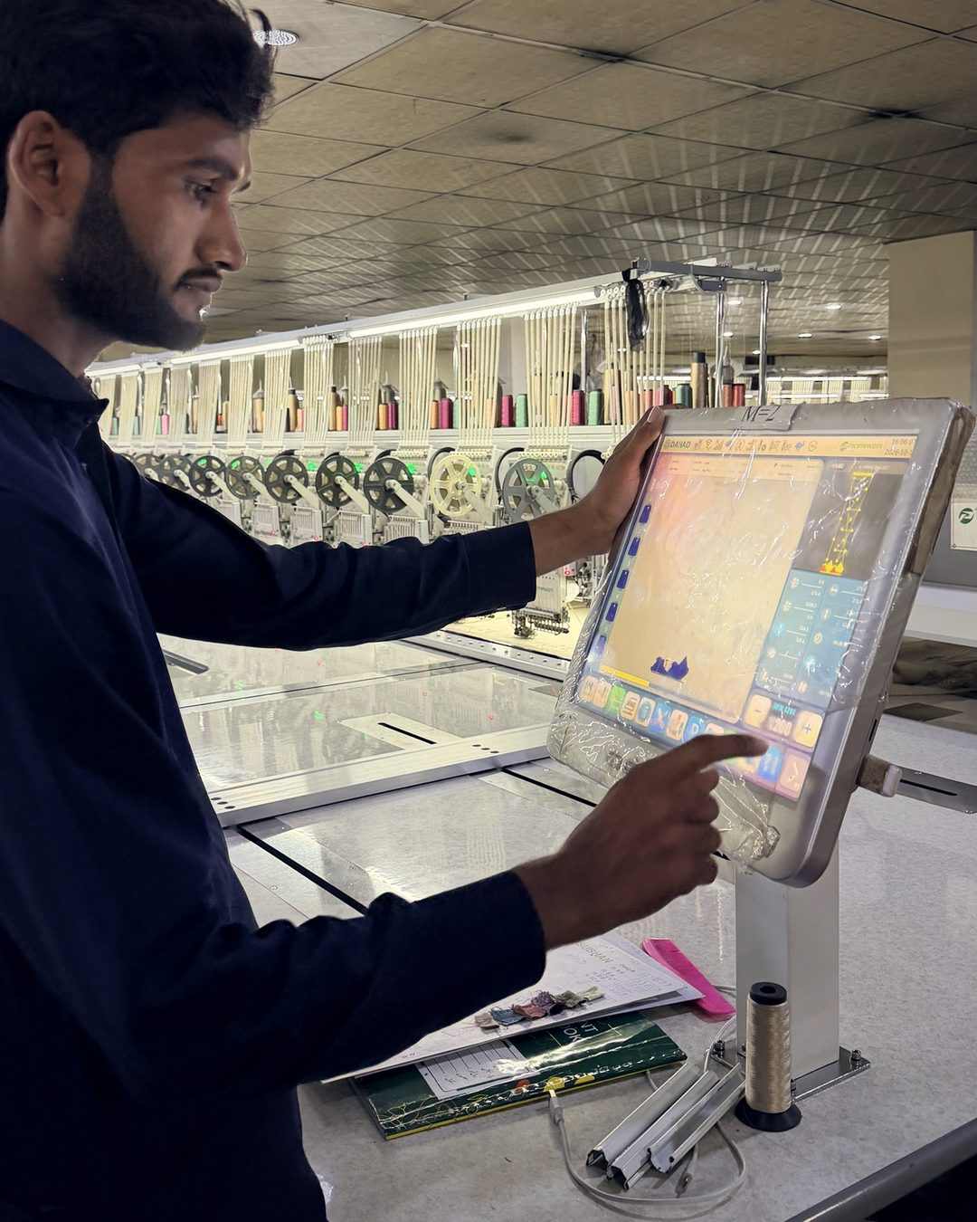 Operator feeding the design into the machine control panel