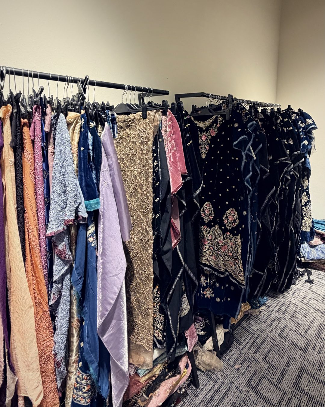 Racks of embroidered samples in velvet, net and silk